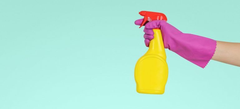 A person holding a chemical sprayer.