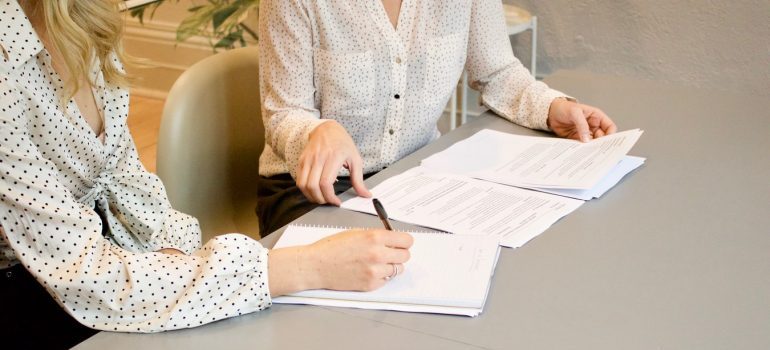 A woman signing a document