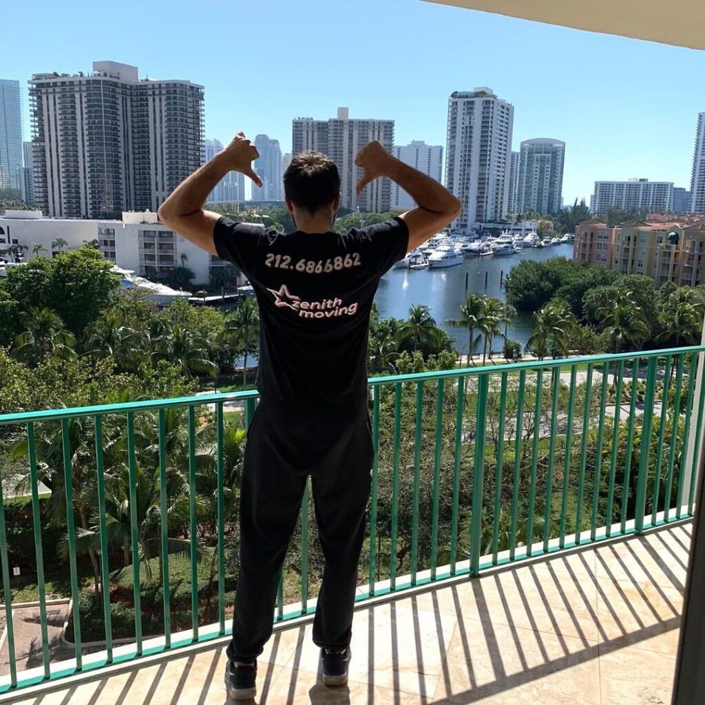 Zenith Moving Team pointing to their Zenith Moving shirt